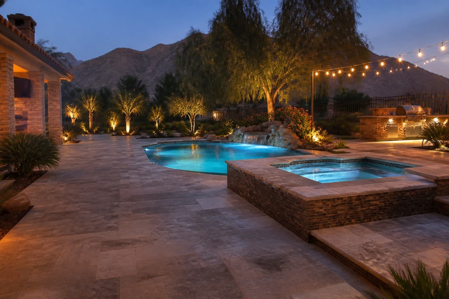Twilight architectural view of a custom pool, spa, and limestone deck